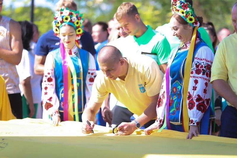 Олімпійці Полтавщини передали естафету паралімпійцям та підписали найбільший прапор області