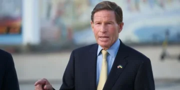 Будівля Капітолію США на тлі прапора