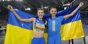 Стрибунка долає планку на змаганнях з легкої атлетики