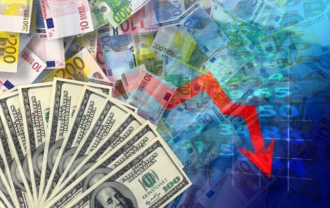 Банкноти долара та євро на тлі графіків